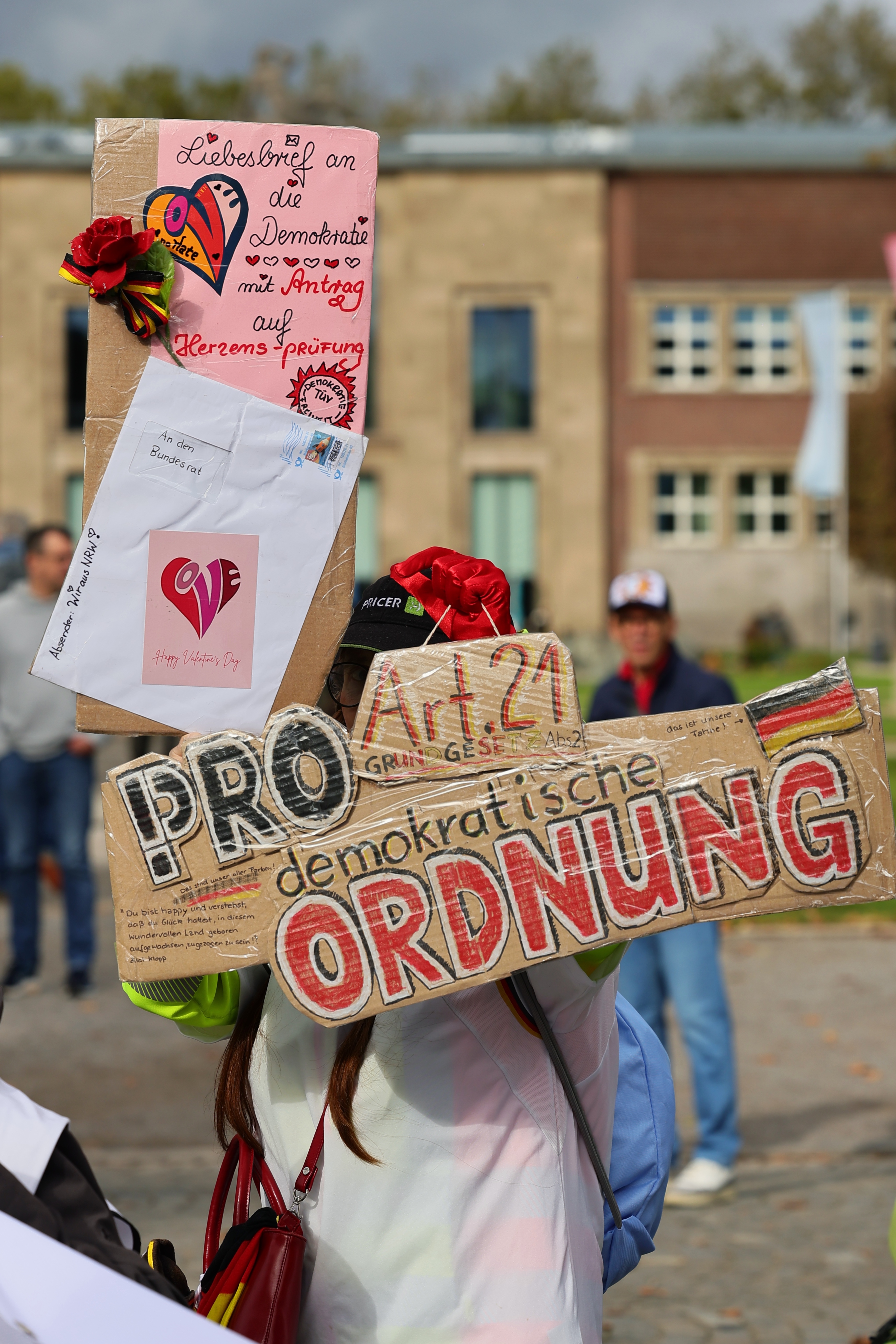 Kostümierte Person mit selbst gestaltetem Schild bei der PRÜF-Demonstration