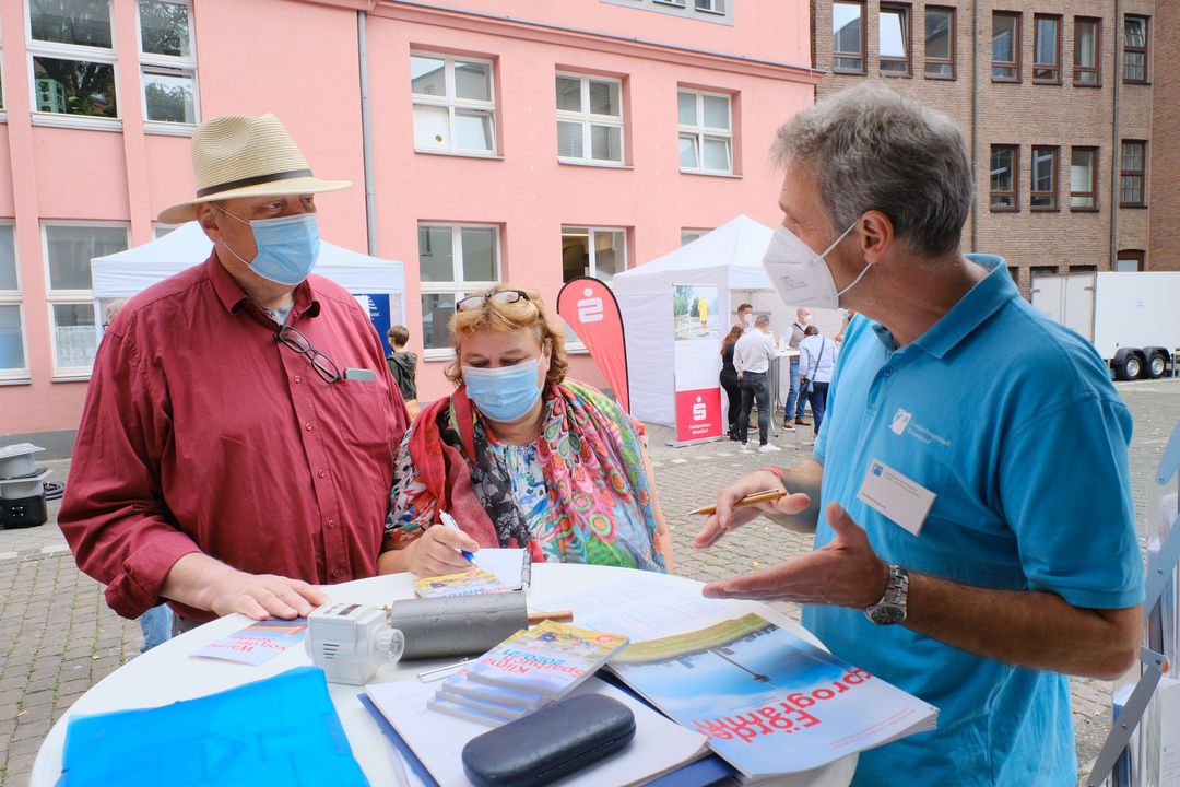 Experten städtischer Ämter, aber auch von Partnern standen am Hochwasserinformationstag, wie hier am Stand der Serviceagentur Altbausanierung, im Innenhof des Rathauses bereit. Sie berieten vom Hochwasser Betroffene individuell © Landeshauptstadt Düsseldorf, Michael Gstettenbauer 