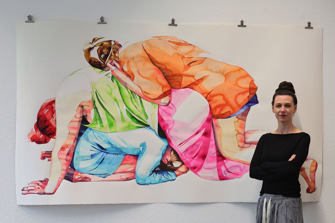 Aline Regese, Malerin und Vorstand des Vereins Düsseldorfer Künstlerinnen (VdK), vor ihren farbintensiven Aquarellen in der Ausstellung „KÜNSTLERINNEN! JETZT!“ in Düsseldorf-Heerdt. / Foto: Klaus von Jackelmann
