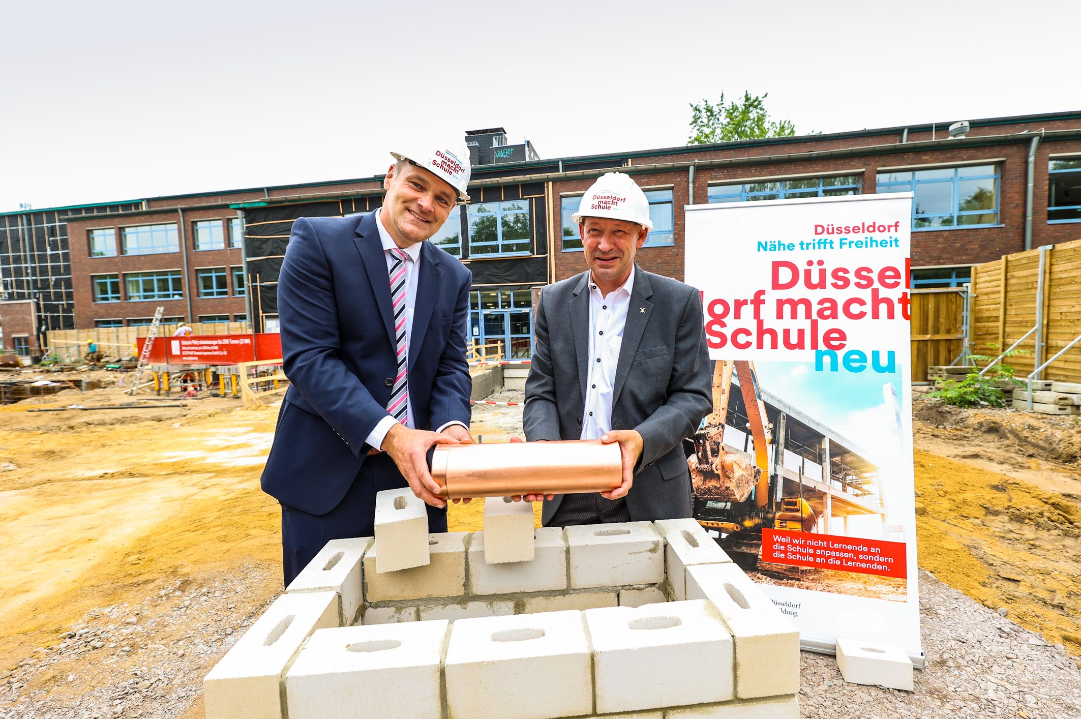 Ein Erweiterungsbau für das Comenius-Gymnasium: Am Montag, 27. Juni, legten Stadtdirektor Burkhard Hintzsche (r.) und Schulleiter Mike Koch den Grundstein für das neue Gebäude © Landeshauptstadt Düsseldorf/Melanie Zanin 