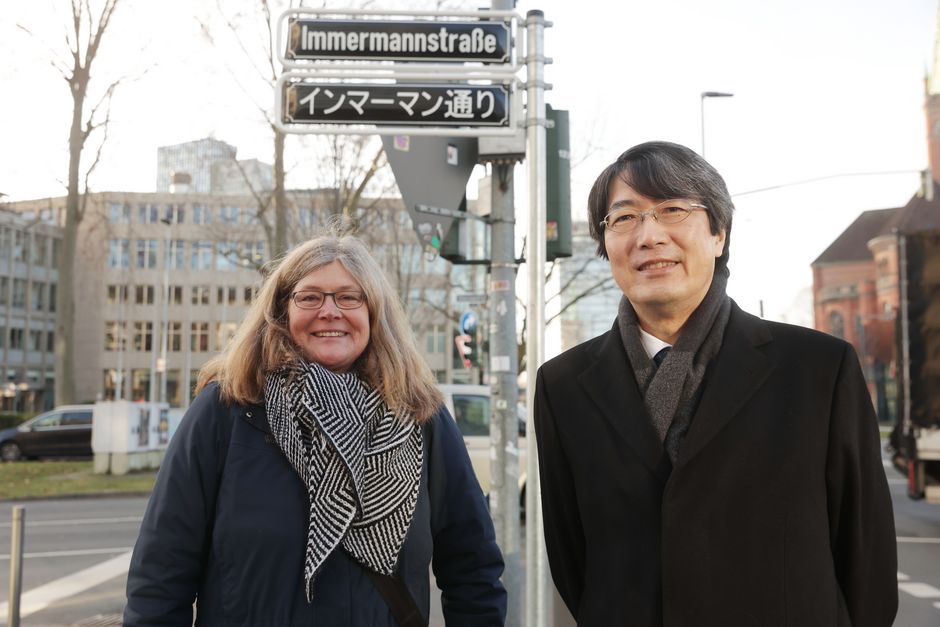 Bezirksbürgermeisterin Annette Klinke und dem japanischen Generalkonsul Kiminori Iwama mit dem neuen Schild an der Immermannstraße auf der Höhe des Ernst-Schneider-Platzes © Landeshauptstadt Düsseldorf/David Young 