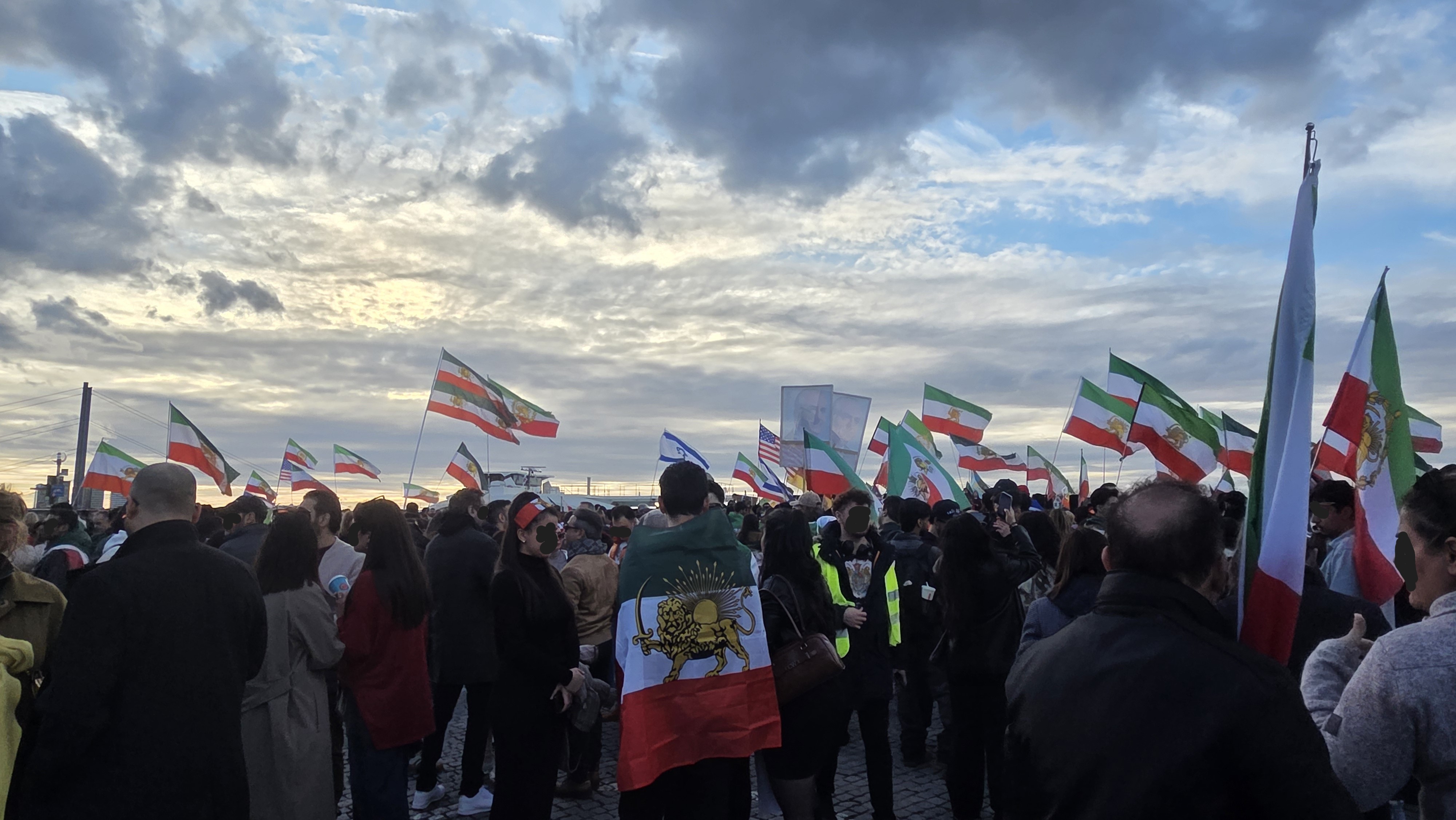 Menschenmenge mit vielen iranischen Fahnen am Burgplatz in Düsseldorf vor dem Schlossturm.