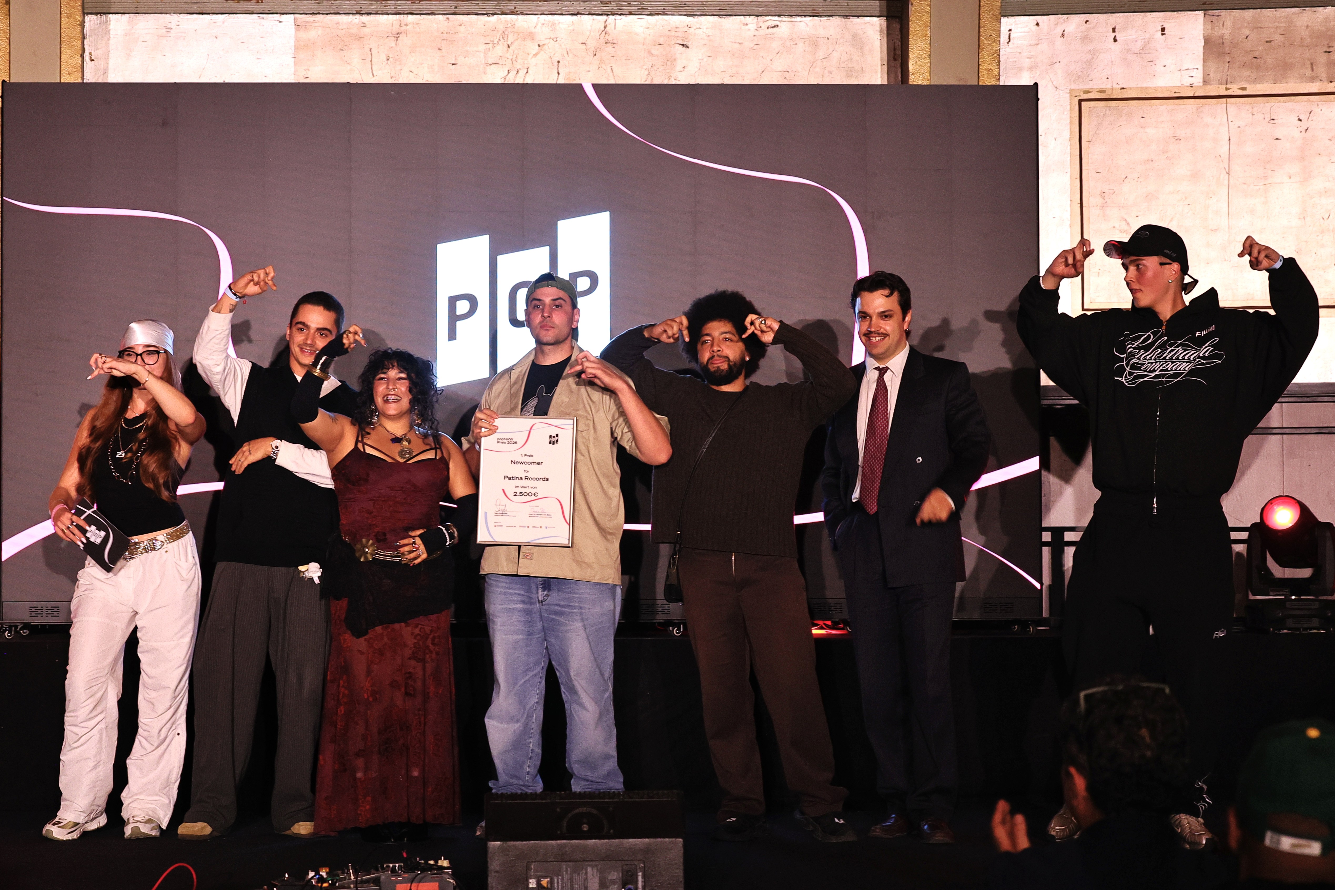 Patina Records gewinnt den Newcomer-Preis Patina Records auf der Bühne mit der Auszeichnung für den ersten Platz der Kategorie Newcomer beim popNRW-Preis 2026.